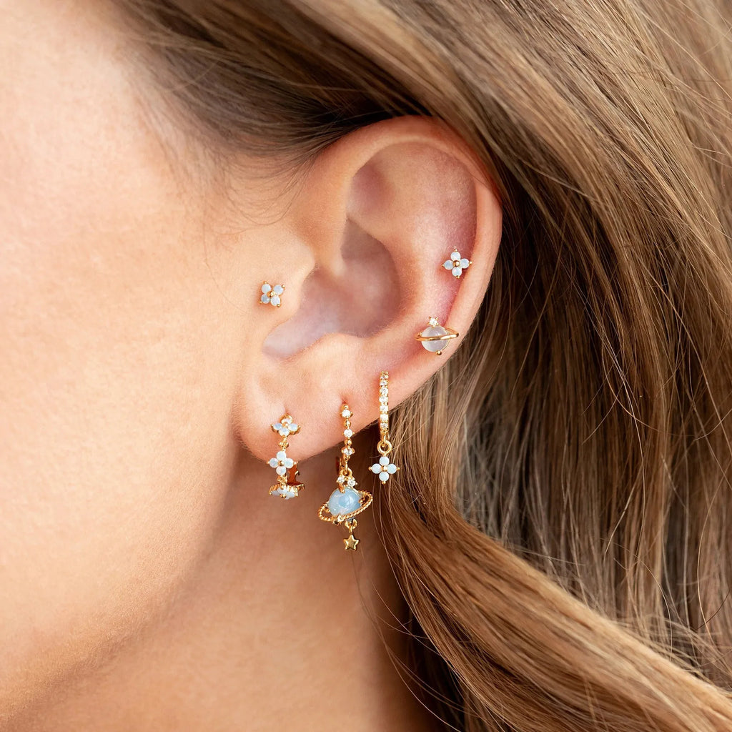 Flower-shaped ear studs with zircon mosaic in gold or silver finish, showing geometric design details