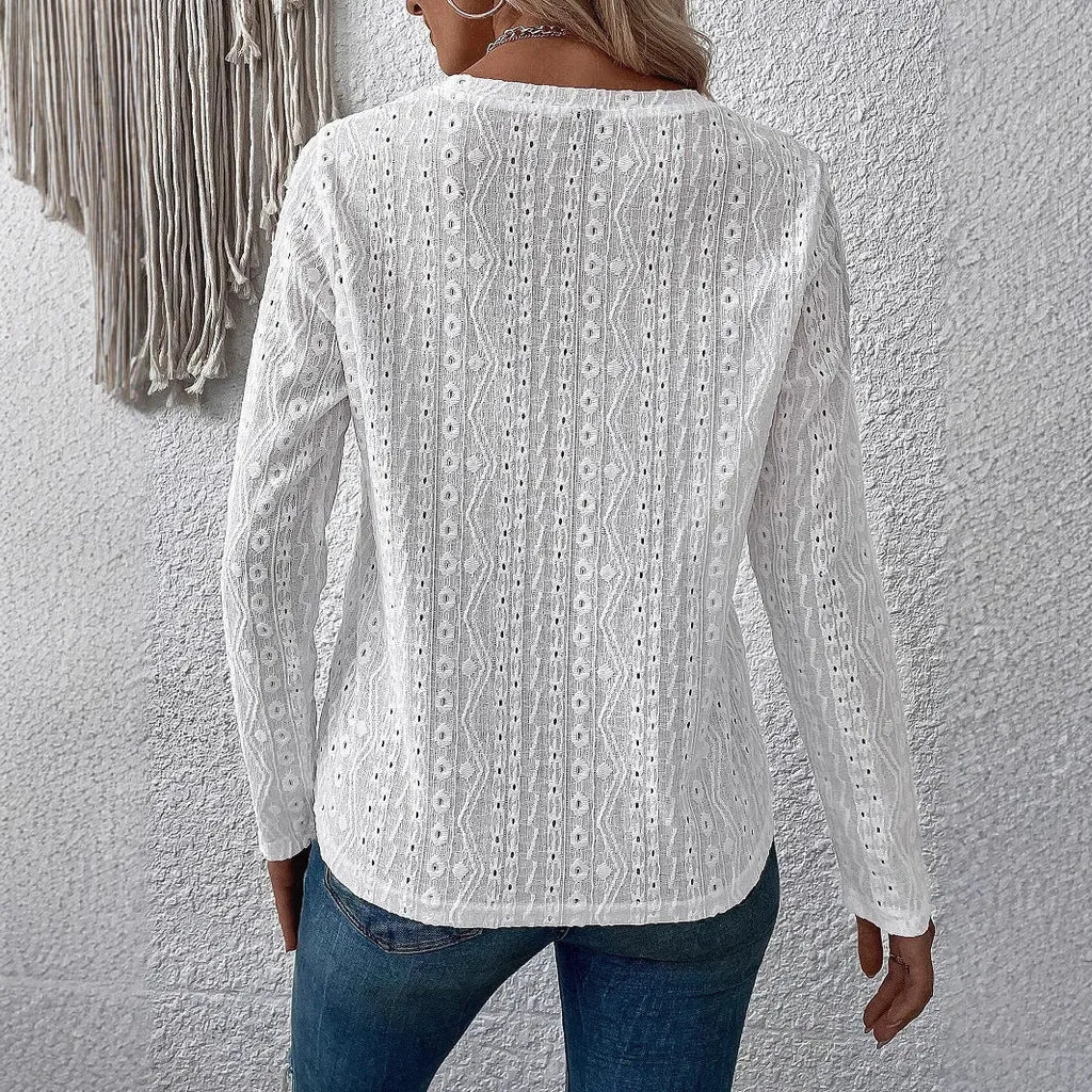 White loose fit long sleeve round neck t-shirt on a hanger