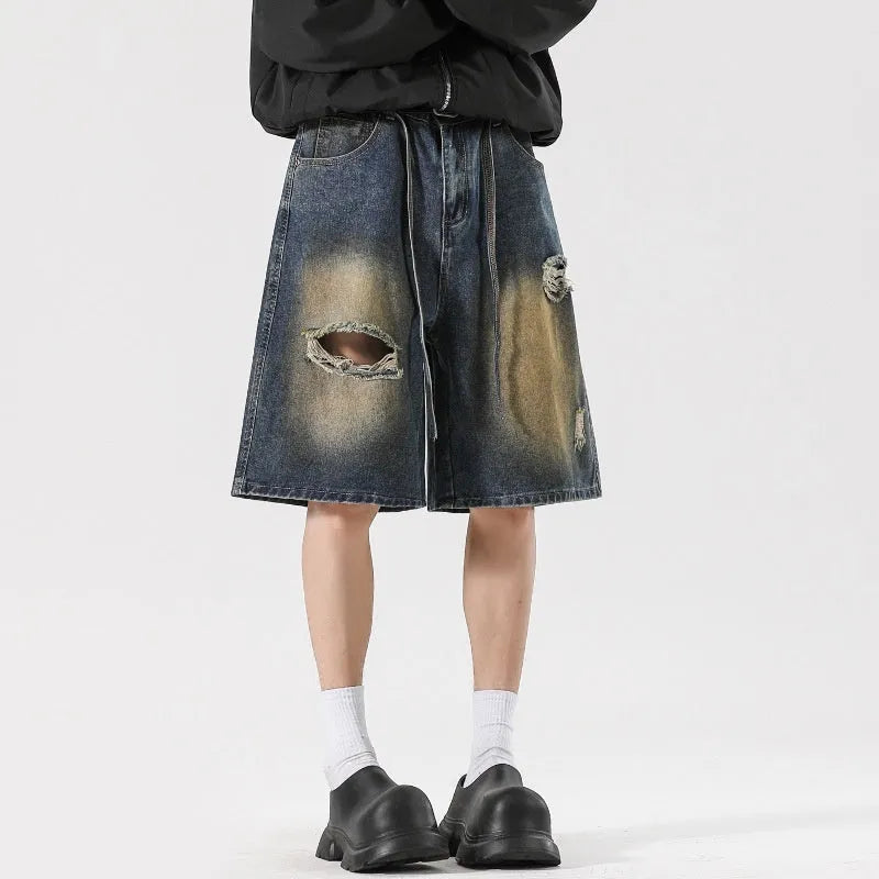 Loose fit retro blue distressed jeans on man showing cotton denim construction and street style detailing
