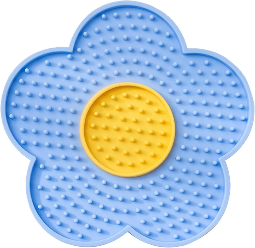 Flower-shaped silicone slow feeder licking mat for dogs and cats with suction cups on a smooth surface.