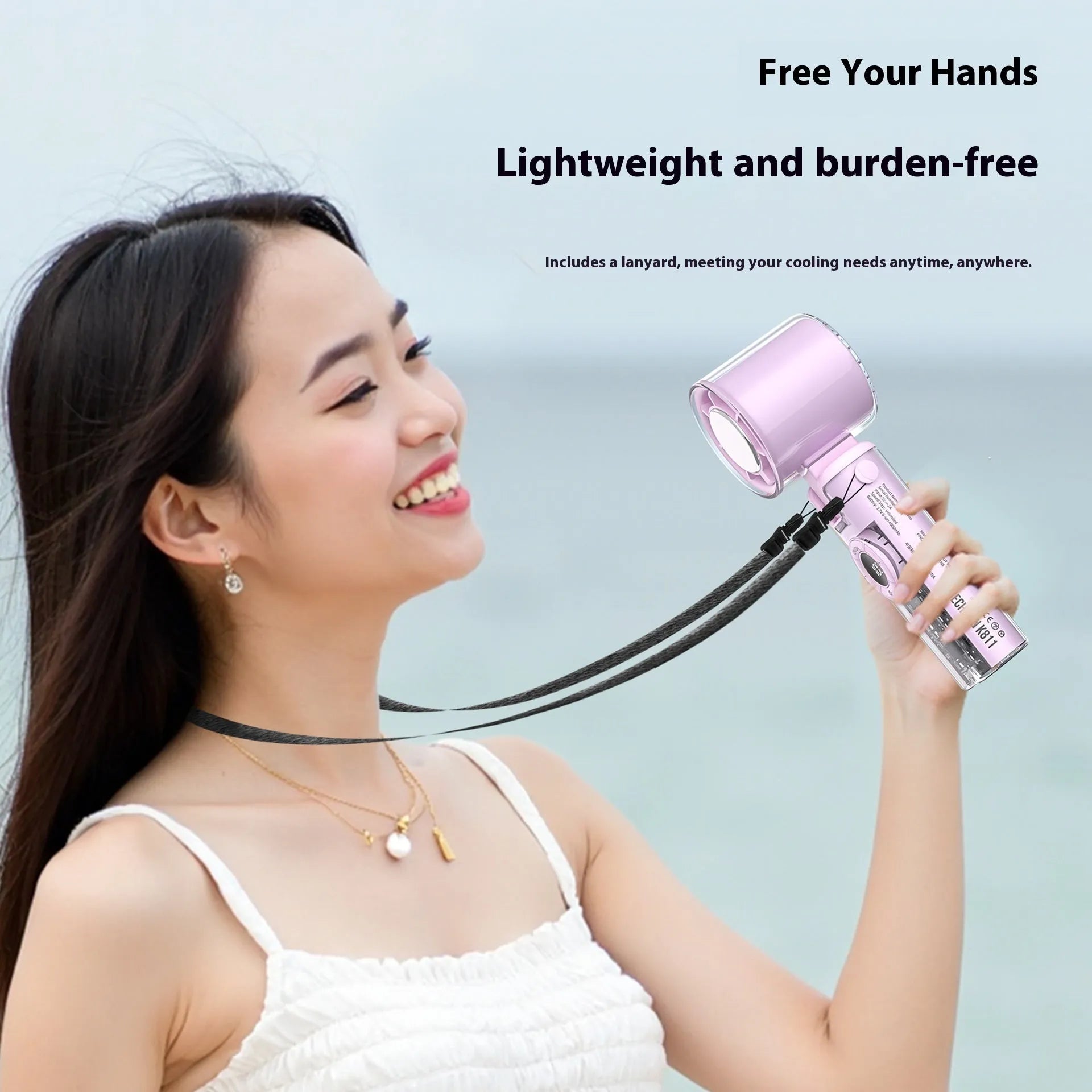 Black handheld personal cooling fan with LED light and neck lanyard strap on white background.