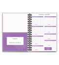 Purple coil-bound financial planning notebook open on a monthly budget page with pen and stickers.