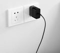 Black ZMI 65W USB-C laptop power adapter showing compact dimensions