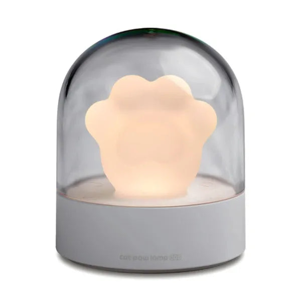 Grey cat paw shaped night light with USB charging port and control button showing soft illumination
