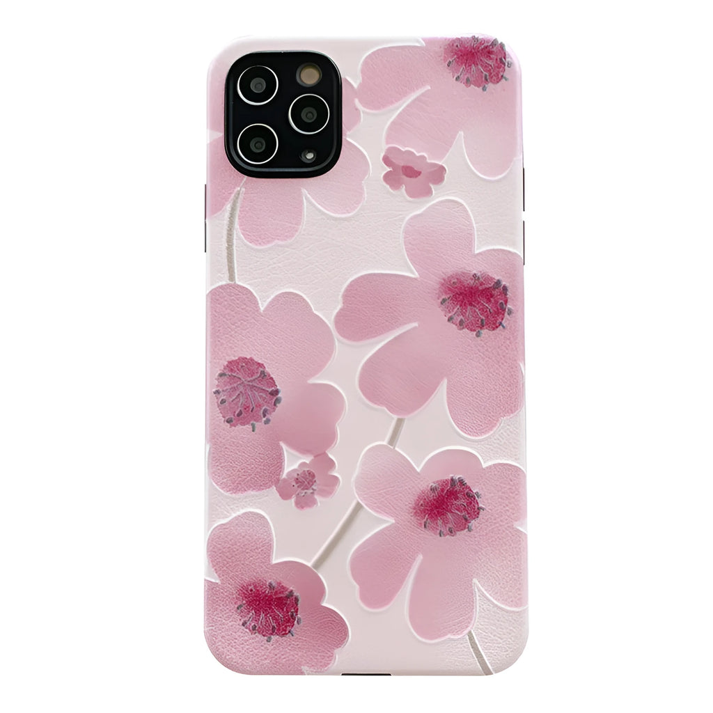 Pink soft rubber flower phone case for iPhone models on a flat surface, showing lanyard hole.