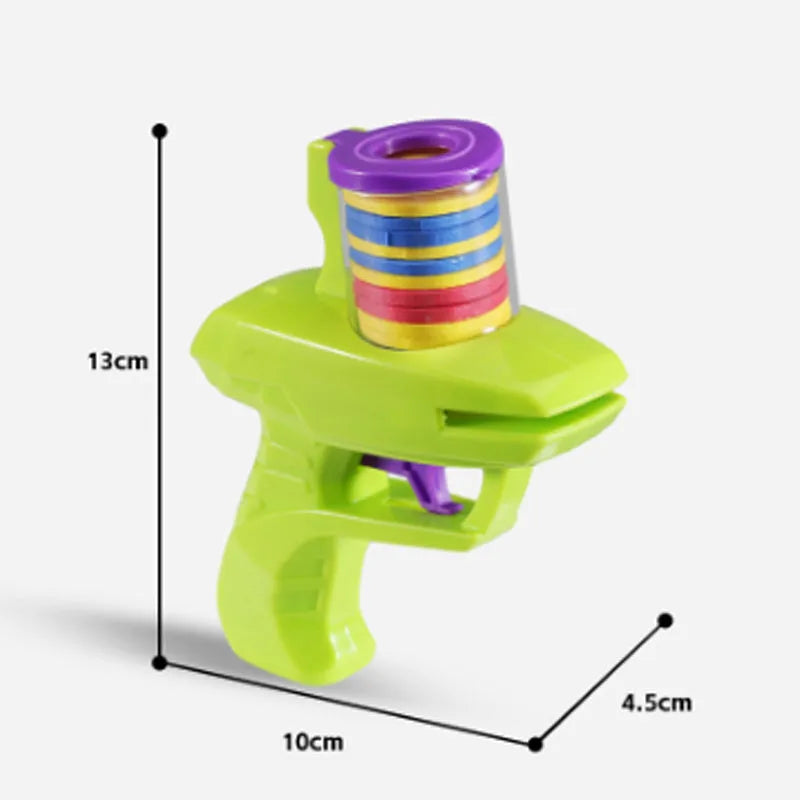 Green interactive cat toy launcher with foam discs on wooden floor
