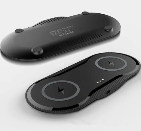 Black and white dual 10W wireless charger charging two phones simultaneously on silicone anti-slip base