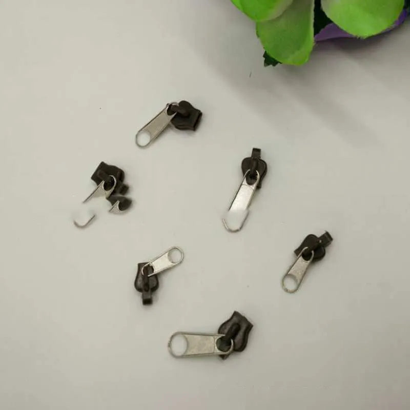 Pack of 12 snap-on zipper head replacements in plastic and metal for quick repair.