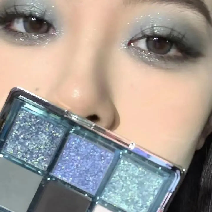 MUGELEEN nine-colour eye shadow palette showing low saturation ice permeable blue and smoked shades with matte and shimmer textures