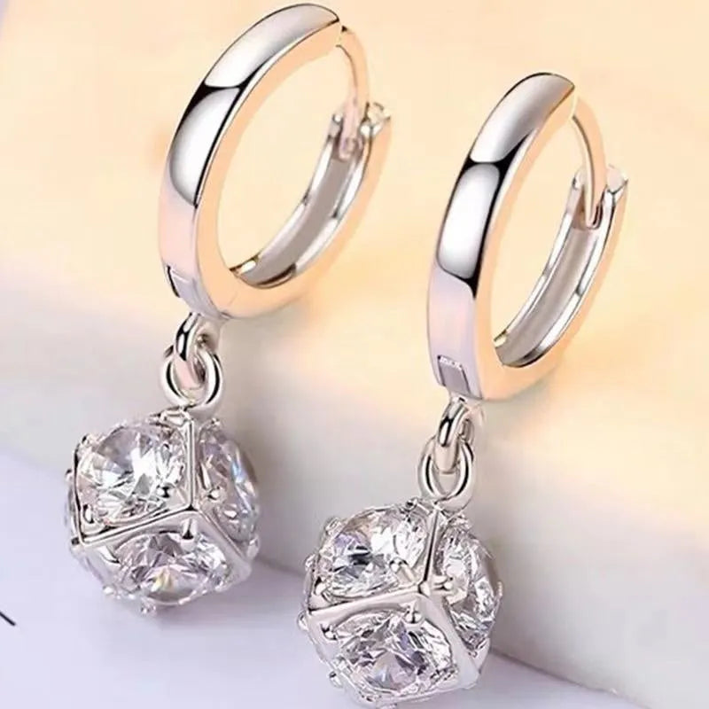 A pair of geometric-shaped zircon and rose element earrings for women, made from electroplated copper.