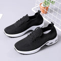 Women's black mesh sneakers with round toe and lace-up front on a white background