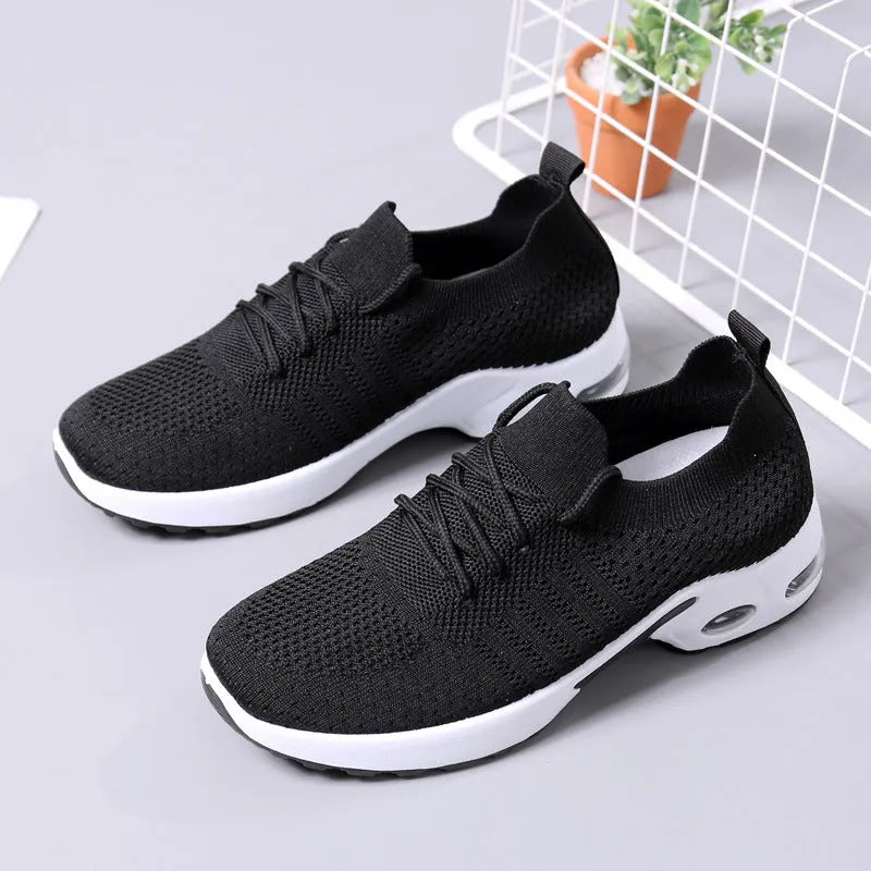 Women's black mesh sneakers with round toe and lace-up front on a white background