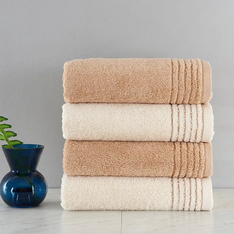 Cotton towel set in brown showing three sizes: large bath sheet, standard bath towel and small hand towel