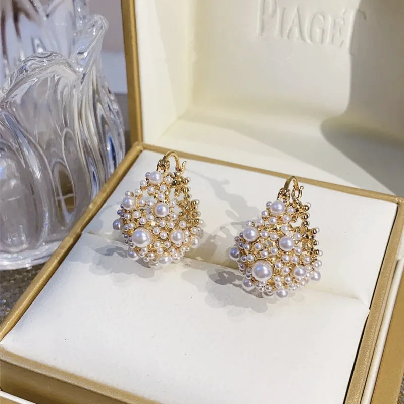 Women's copper flower basket earrings with small rice-shaped beads in gold finish, approximately 3-4 cm diameter