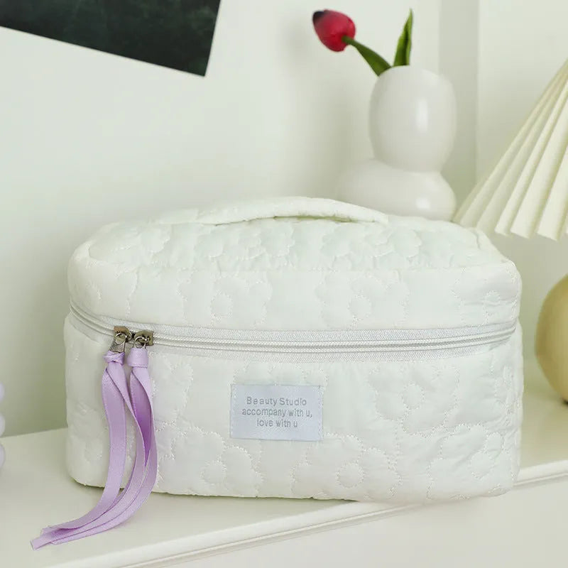 Silk quilted cosmetic bag in candy colours showing quilted pattern and storage capacity