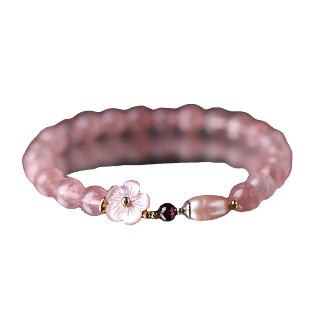 Strawberry quartz crystal bracelet with peach blossom floral design on wrist, showing adjustable 18-20cm length