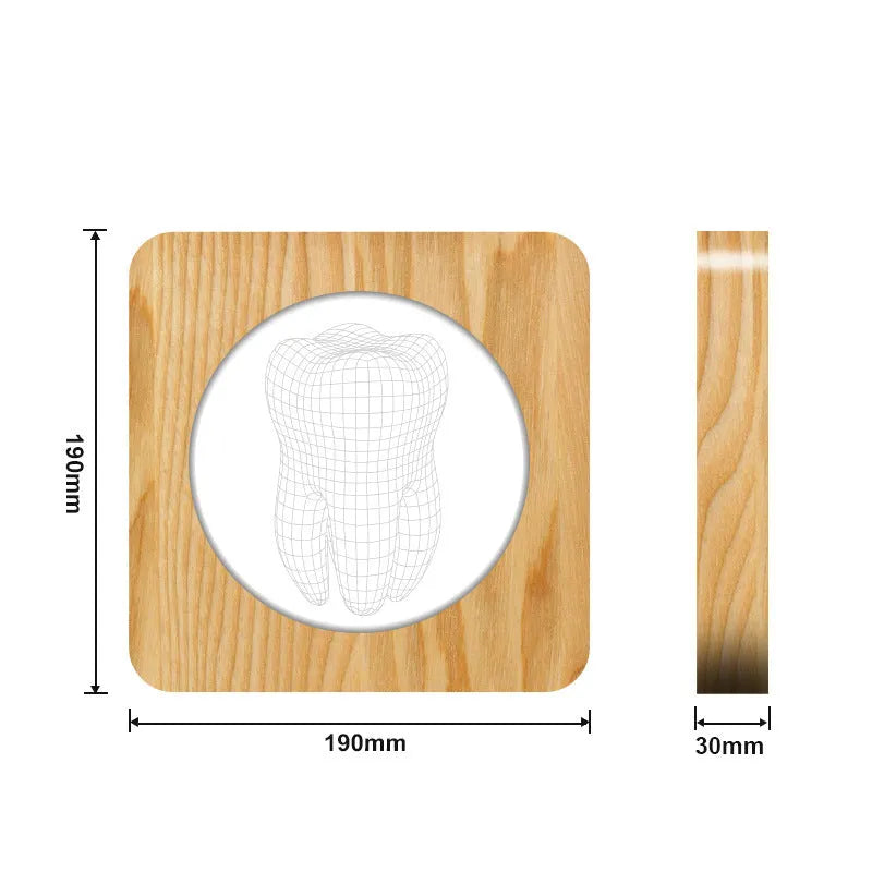 Tooth-shaped wood colour night lamp with USB cable on wooden surface