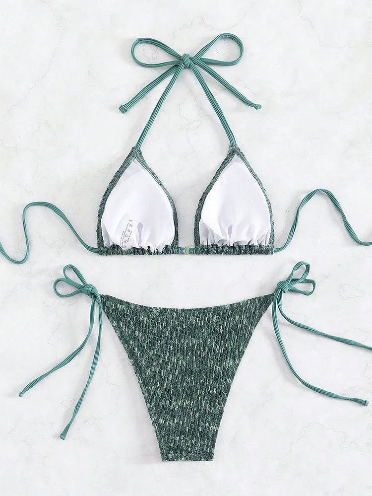 Green women's halter backless swimsuit set with matching shorts