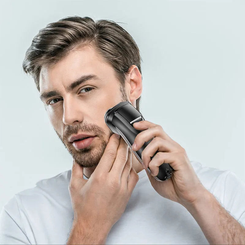 RSCX-7571 men's electric shaver with USB cable, pop-up trimmer, and cleaning brush on grey background