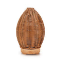 Light wood grain hollow rattan aroma diffuser with 100ml water tank on a wooden surface.