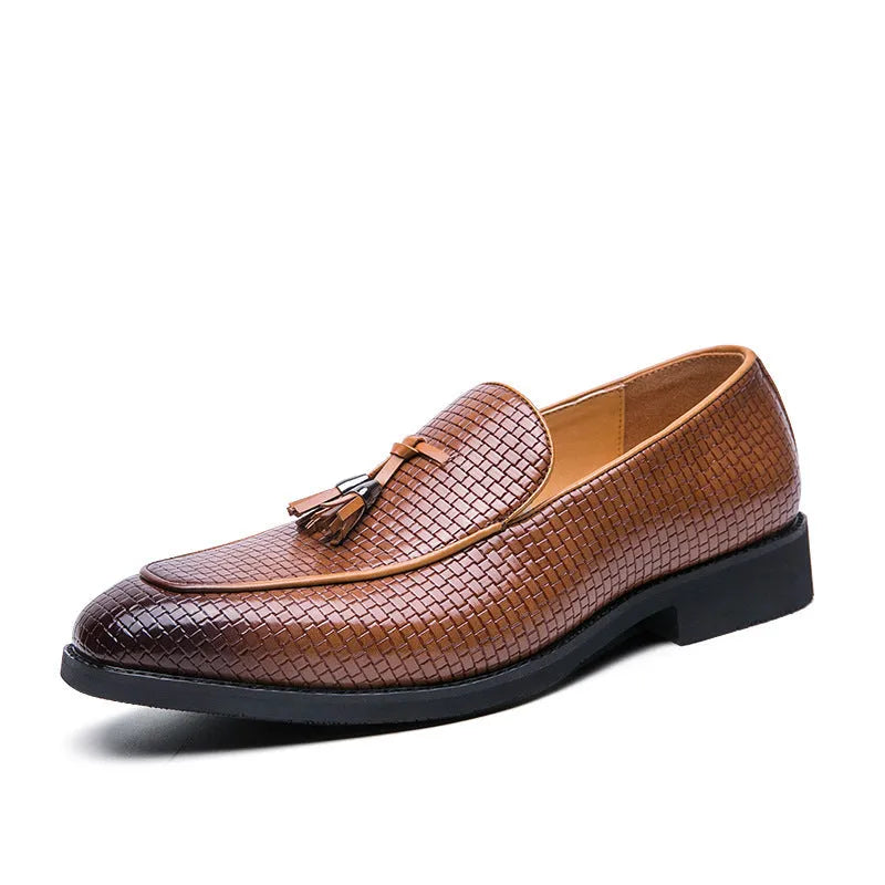 Men's black pointed slip-on leather shoes with tassel detailing on a low-top upper for business wear