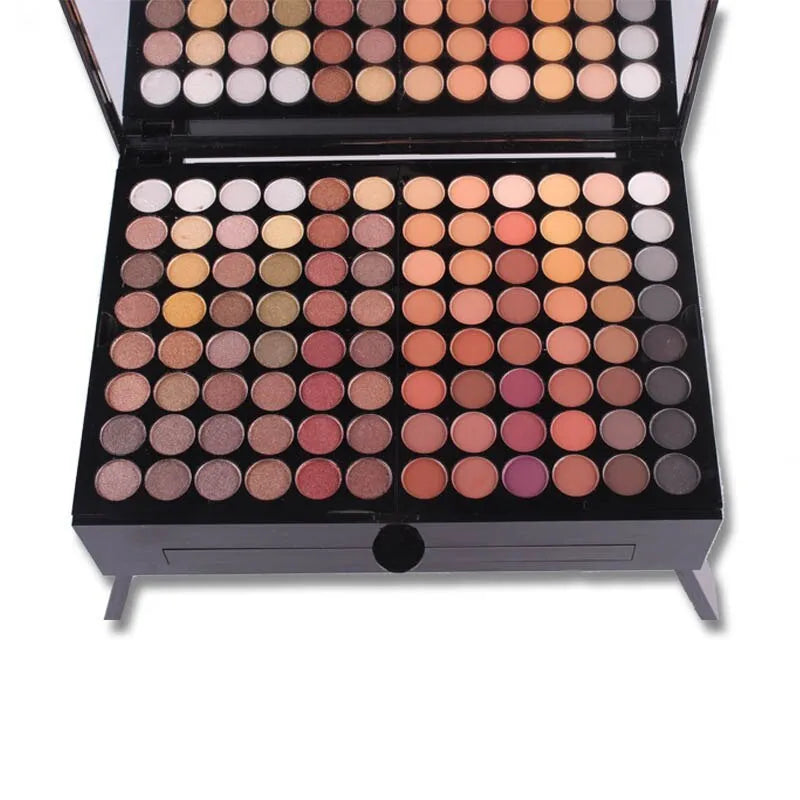 Piano-shaped makeup palette open to show 180 eyeshadow colours, blushes, powders and contour shades