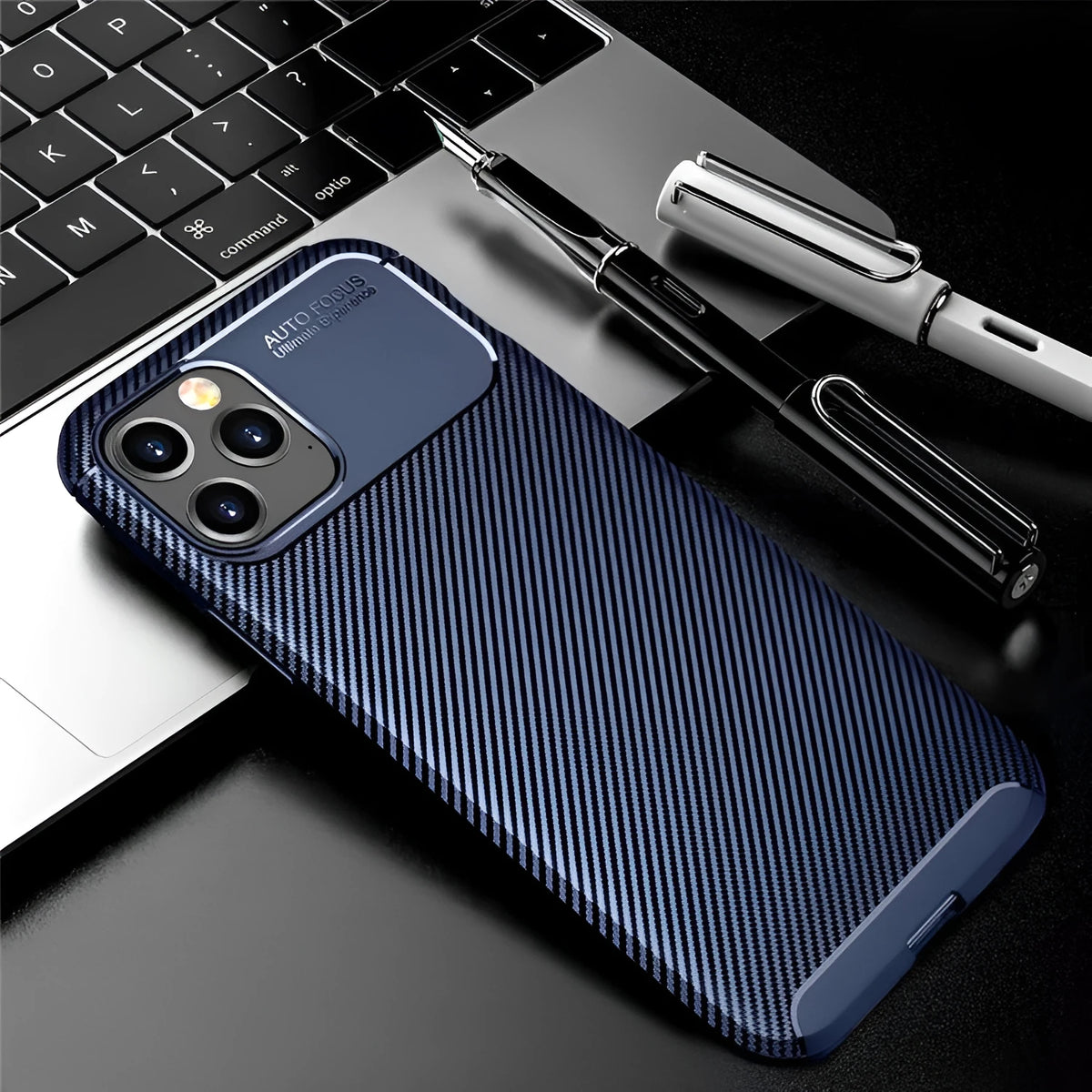 Black silicone iPhone 12 case with simple beetle design on a table.