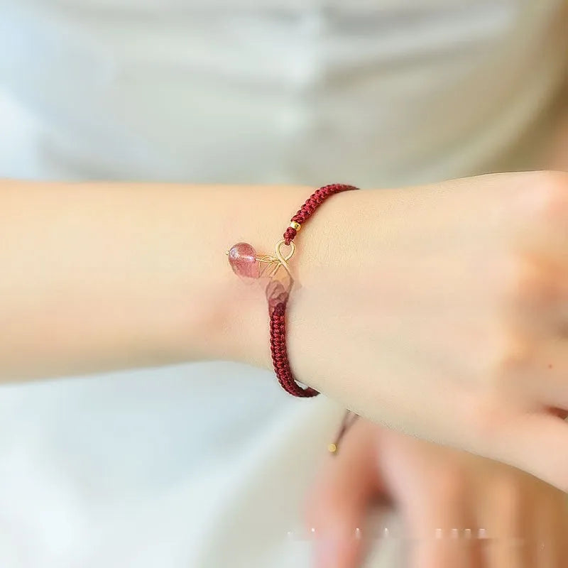 Adjustable strawberry quartz cherry bracelet with 8mm beads on wrist showing natural inclusions