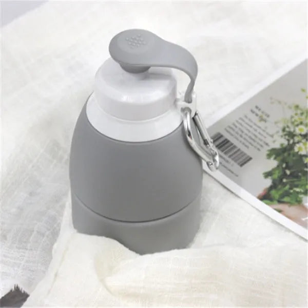 Blue silicone folding water bottle shown full at 22cm tall and folded flat at 11cm tall
