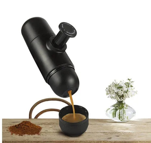 Black portable manual coffee machine showing compact size for travel