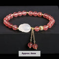 Handcrafted women's bracelet with strawberry quartz and agate beads featuring a white rabbit design.