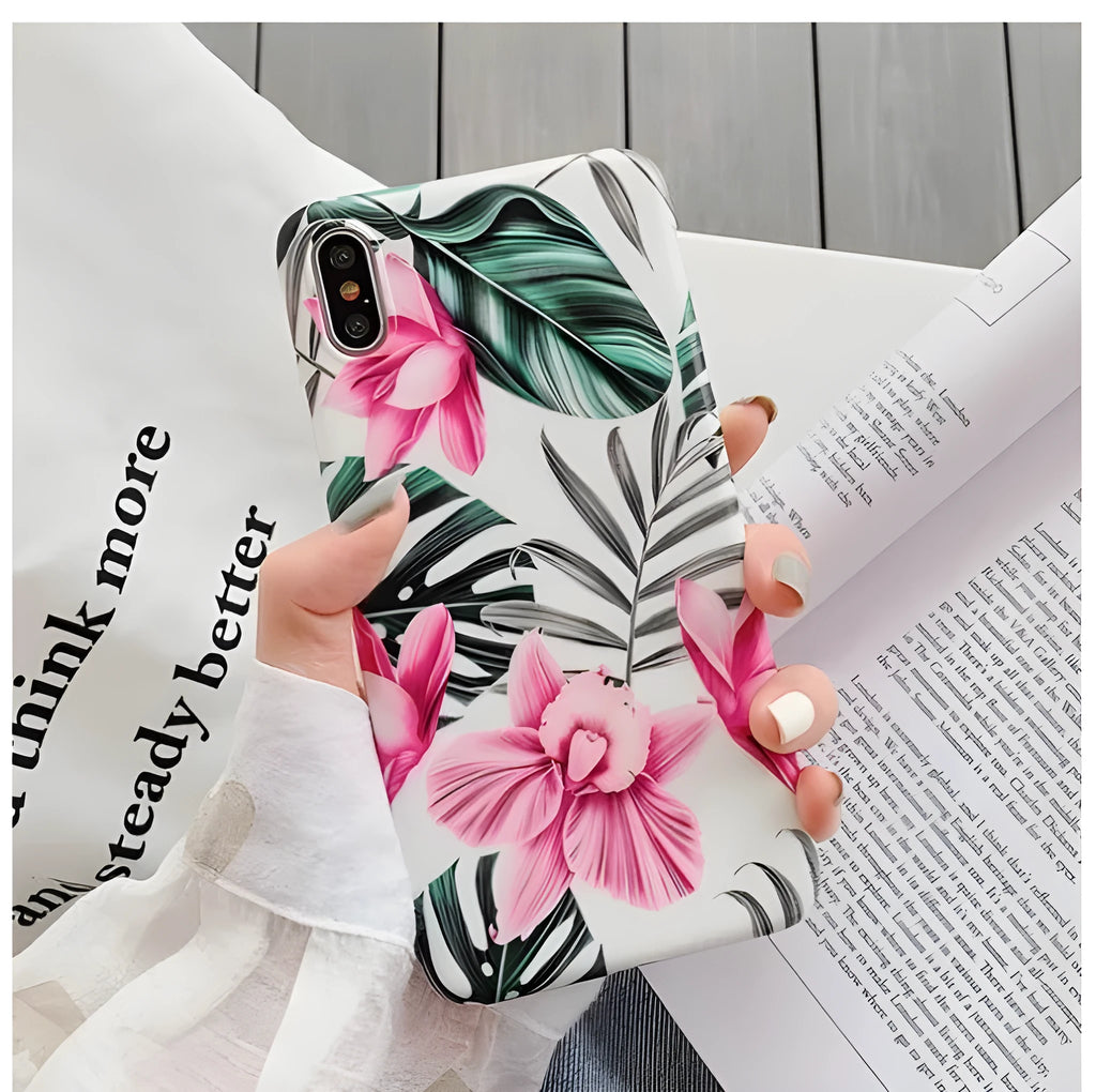 Pink flower design TPU phone case for iPhone on a table.