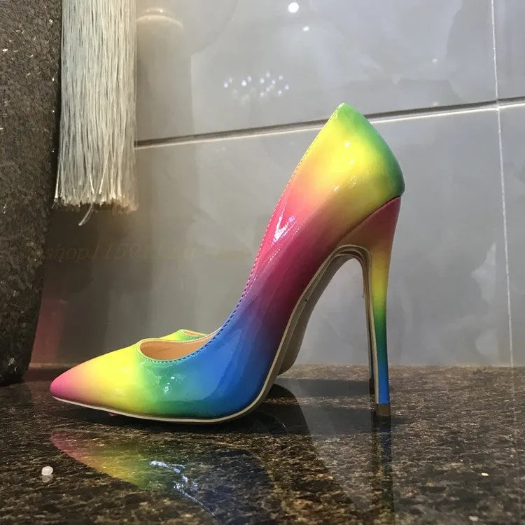 Rainbow coloured patent leather high-heel shoes with a thin stiletto heel and pointed toe on a white background.