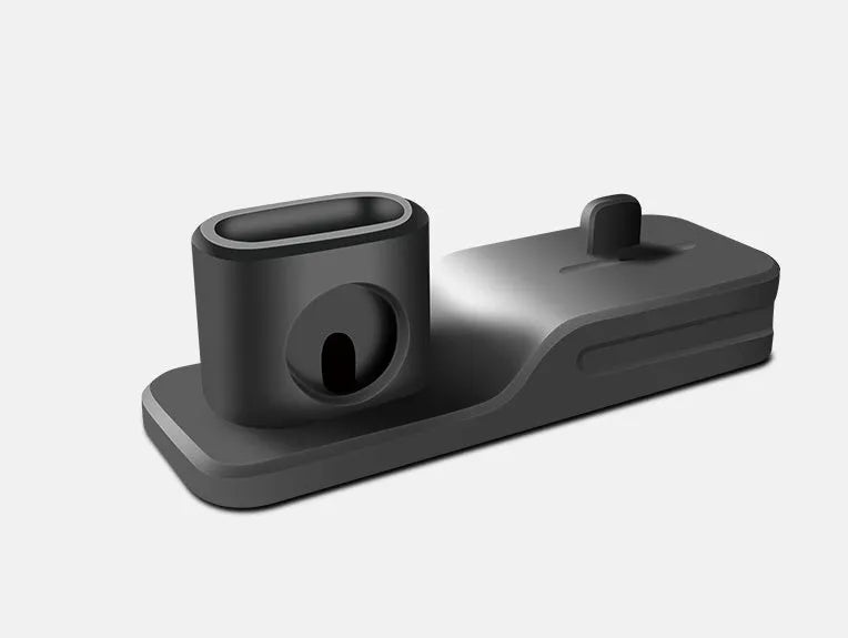 Black silicone 3-in-1 charging stand for iPhone, iWatch, and AirPods on a desk