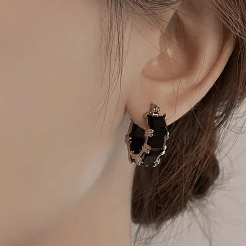 Geometric U-shaped zircon ear rings with electroplated gold finish on copper construction