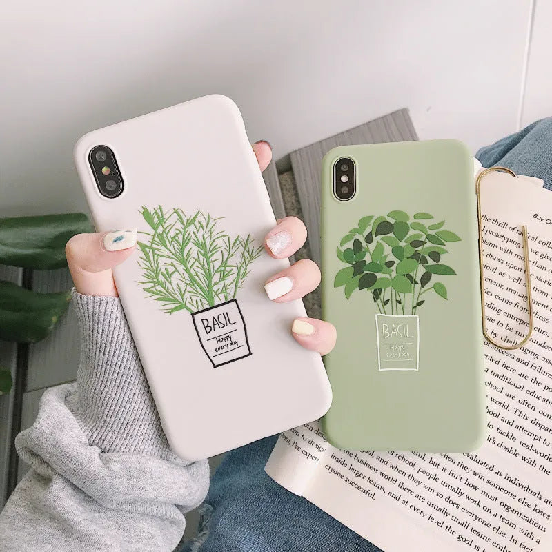 White silicone iPhone case with a detailed painted leaf and plant pattern on the back.