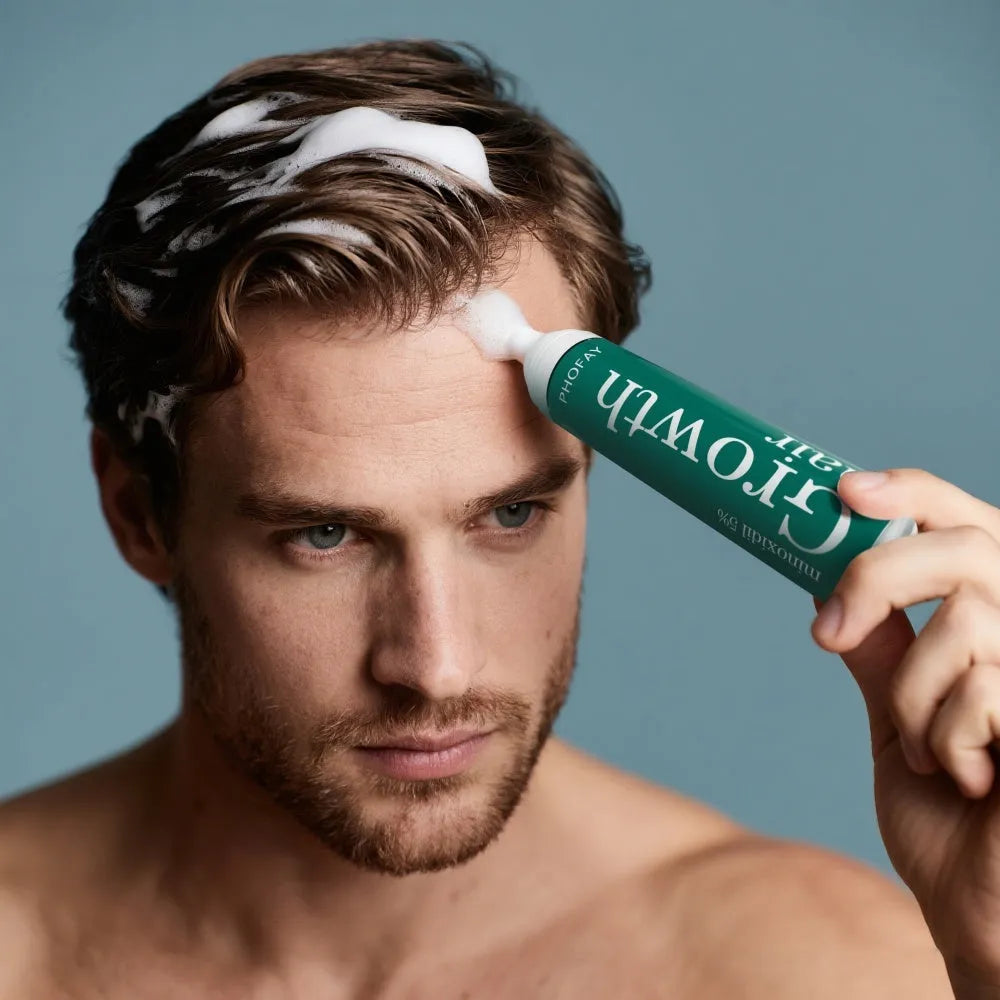 60ml canister of 5% minoxidil anti-hair loss foam mousse with a white pump applicator.