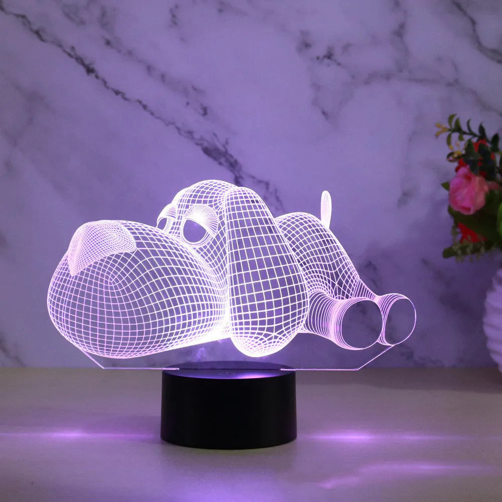 Doggo shaped 3D illusion desktop lamp glowing in multiple colours on a desk.