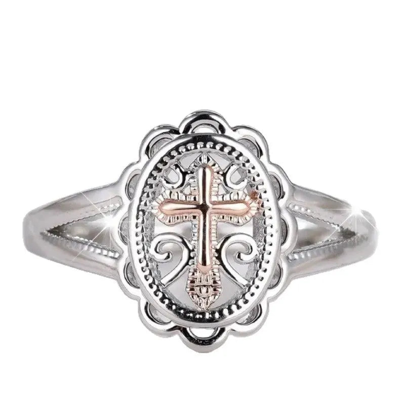Silver coloured women's ring with a detailed cross charm featuring a lace pattern.