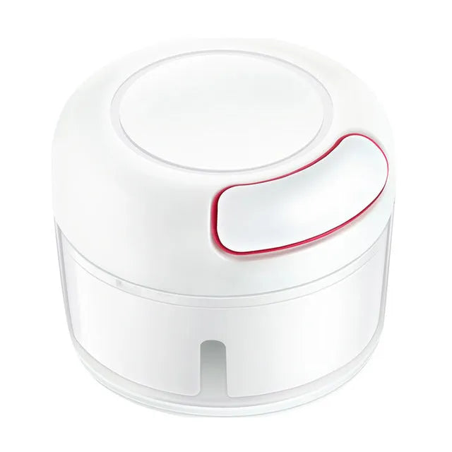 White manual food chopper with stainless steel blades on a magnetic holder, shown with chopped vegetables.