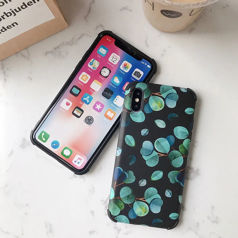 Black silicone iPhone case with a green leaf and botanical floral print design.