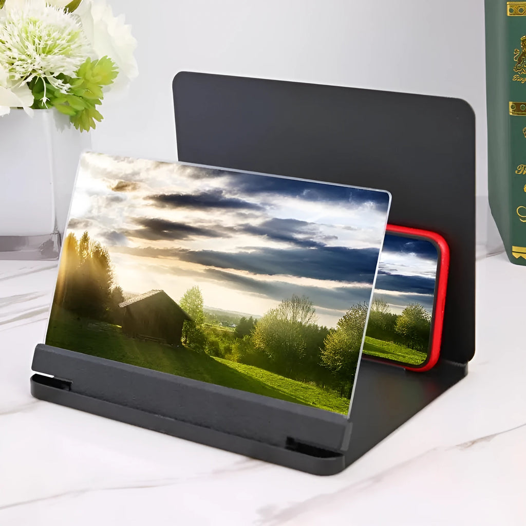 White 9-inch phone screen amplifier with plexiglass lens on a fibreboard base next to a smartphone.