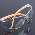 Transparent yellow safety goggles made of polycarbonate for eye protection.