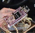 A matte silicone iPhone case with a perfume bottle bow design and a detached metal chain strap.