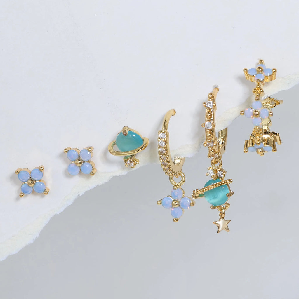 Flower-shaped ear studs with zircon mosaic in gold or silver finish, showing geometric design details