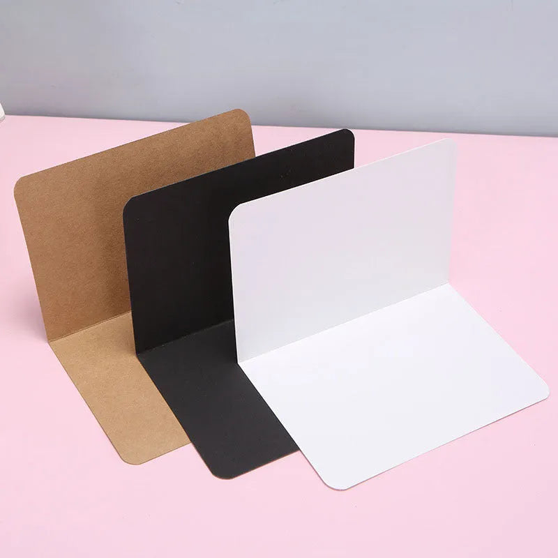 Kraft paper folded greeting cards in black, brown and white showing 10x15cm size