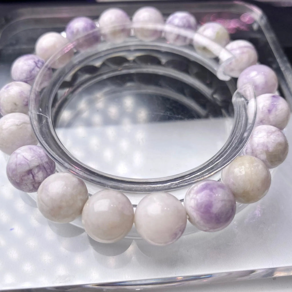 Natural purple turquoise bead bracelet for women on a white background, showing adjustable string tie.