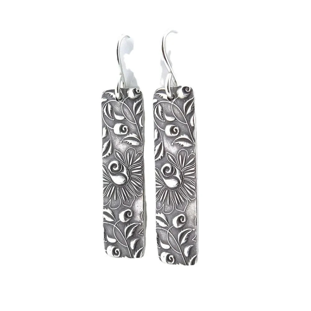 Silver geometric long earrings with carved vine detailing measuring 20 cm