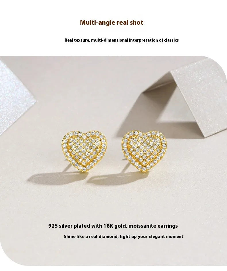 Golden heart-shaped moissanite stud earrings with sterling silver posts and butterfly backs