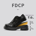 Black low-top platform leather shoes with round toe and rubber sole.